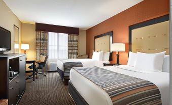 a hotel room with two beds , a desk , and lamps , as well as a window and curtains at Country Inn & Suites by Radisson, Evansville, IN