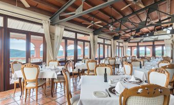 a large dining room with tables and chairs arranged for a group of people to enjoy a meal at Monnaber NOU Finca Hotel & Spa