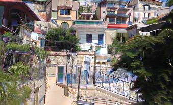 a group of colorful buildings with balconies and railings , surrounded by a fence and a fence at Off The Square