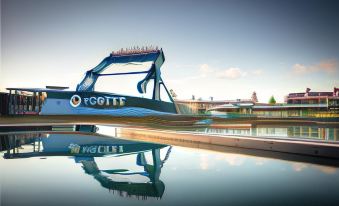 a large water slide with a blue and white color scheme is reflected in the water at Paradise Country Farmstay