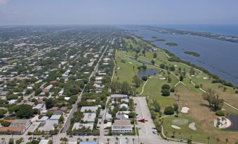 a bird 's eye view of a residential area with houses , trees , and a golf course at Sabal Palm House Bed and Breakfast