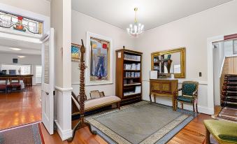 a room with a wooden floor , a rug on the floor , and various pieces of furniture at Seaview House