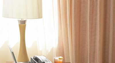 a room with a window , curtains , and a telephone next to a small bowl of food at Country Inn & Suites by Radisson, Watertown, SD