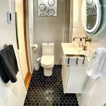 Live in this iconic East Side lower level apartment