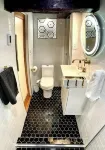 Live in this iconic East Side lower level apartment