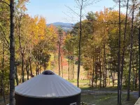 Elevated eclectic yurt with wrap-around porch, hot tub, and mountain view! Hotels in Piper Gap
