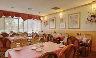 a dining room with tables and chairs arranged for a group of people to enjoy a meal together at Days Inn by Wyndham Lanham Washington DC