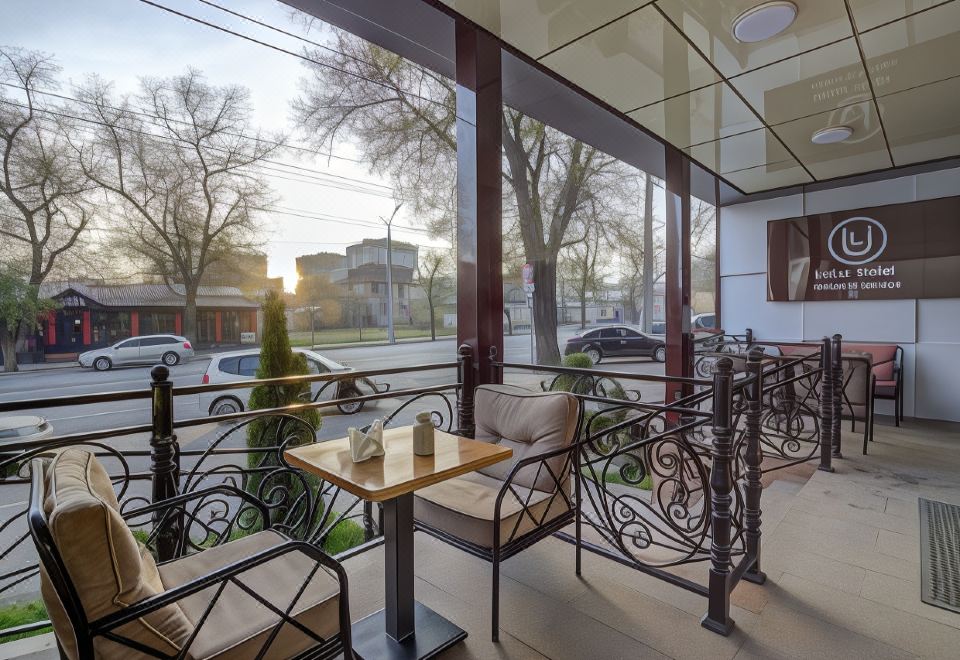 a balcony with a table and chairs , providing a cozy outdoor seating area for people to enjoy at Hotel Lulu