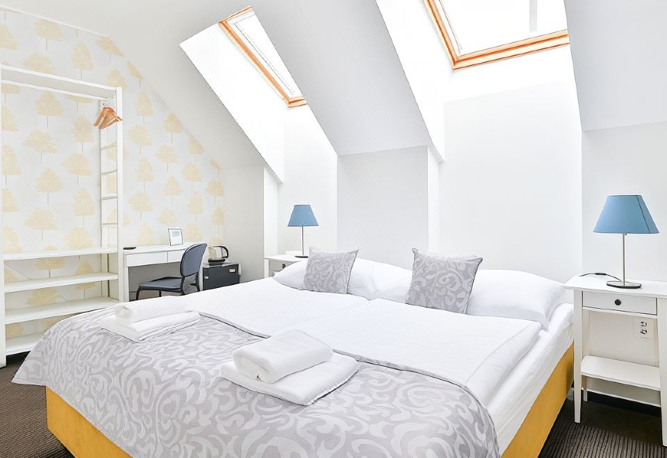 a modern bedroom with two beds , one on top of the other , and white walls at BlueBell Hotel