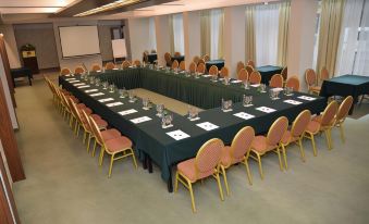 a large conference room with a long table and multiple chairs arranged for a meeting at Hotel Bellevue