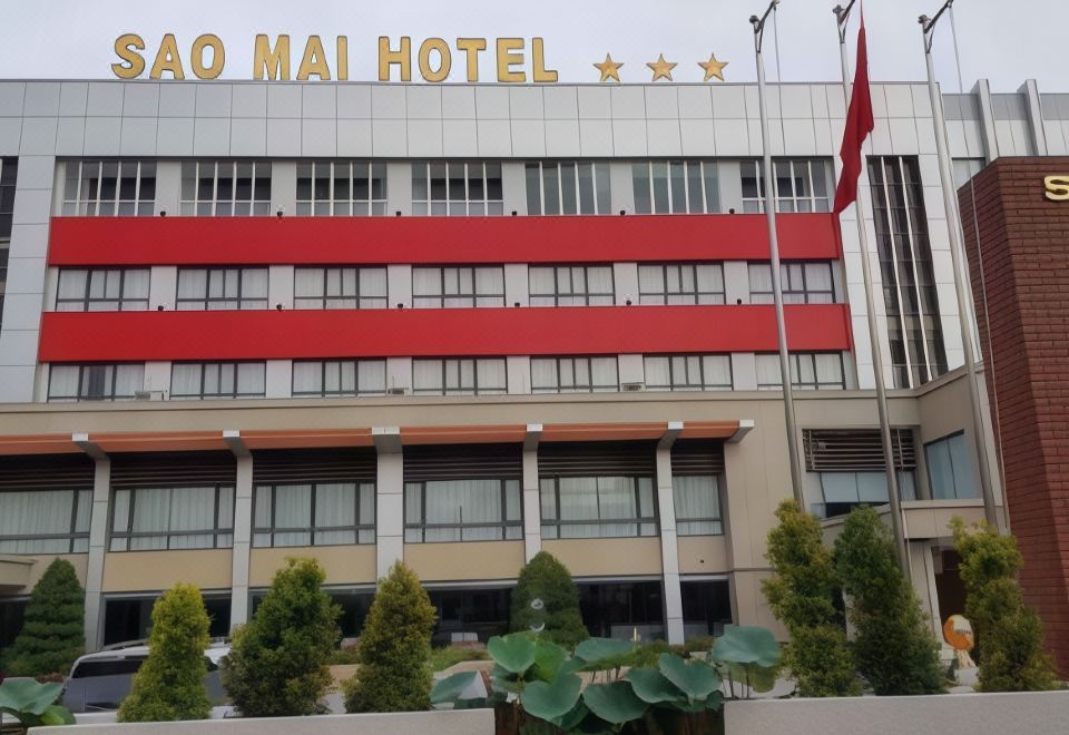 "a large red hotel building with the words "" lao mai hotel "" prominently displayed on the front" at Sao Mai Hotel