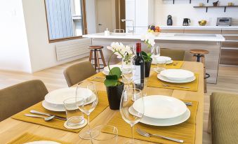 a dining room with a table set for a meal , complete with plates , cups , and utensils at Birchwood Chalet