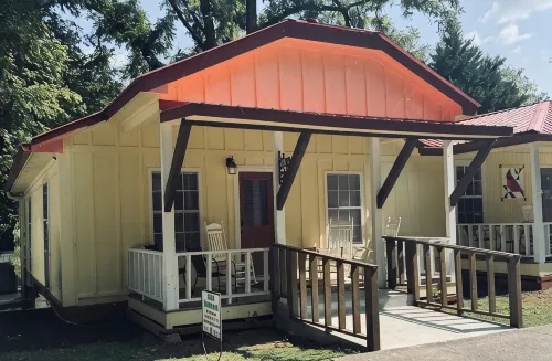 Downtown by Chattahoochee River, sit on front porch as horse and buggy stroll by