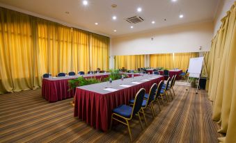 a large conference room with several long tables and chairs arranged for a meeting or event at Amverton Heritage Resort