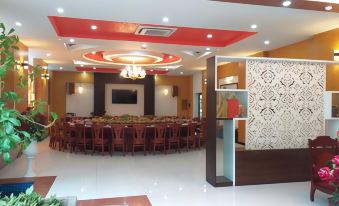 a large , empty banquet hall with multiple dining tables and chairs set up for a party or event at Sao Mai Hotel