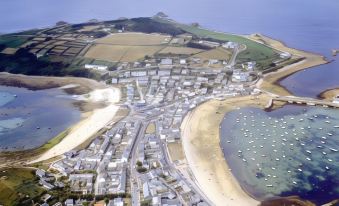 a bird 's eye view of a city with white buildings , green fields , and blue water at The Atlantic