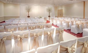 a large banquet hall with rows of chairs arranged in a formal setting , ready for an event at DoubleTree by Hilton Manchester Airport