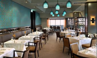 a well - lit dining room with tables and chairs arranged for a group of people to enjoy a meal together at Mindil Beach Casino Resort