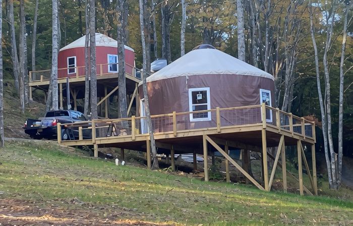 Elevated eclectic yurt with wrap-around porch, hot tub, and mountain view!