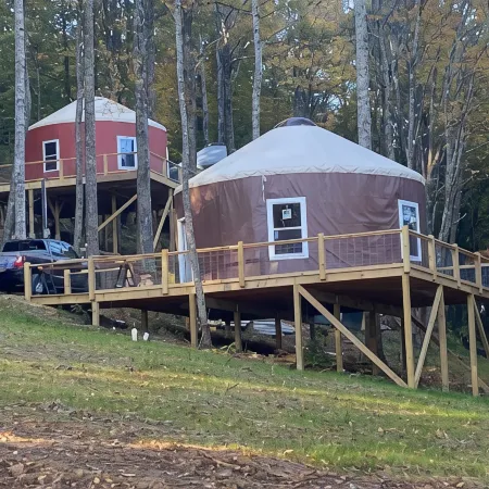 Elevated eclectic yurt with wrap-around porch, hot tub, and mountain view!