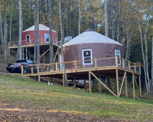 Elevated eclectic yurt with wrap-around porch, hot tub, and mountain view! Hotels in Piper Gap