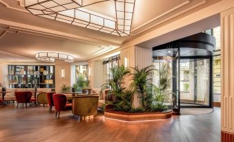 a modern living room with wooden floors , white walls , and large windows , decorated with potted plants and artwork at Only You Hotel Valencia