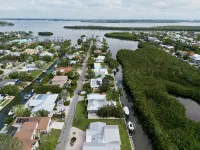 Cute canal front Cottage with dock & boat lift and pool ,short walk to the beach