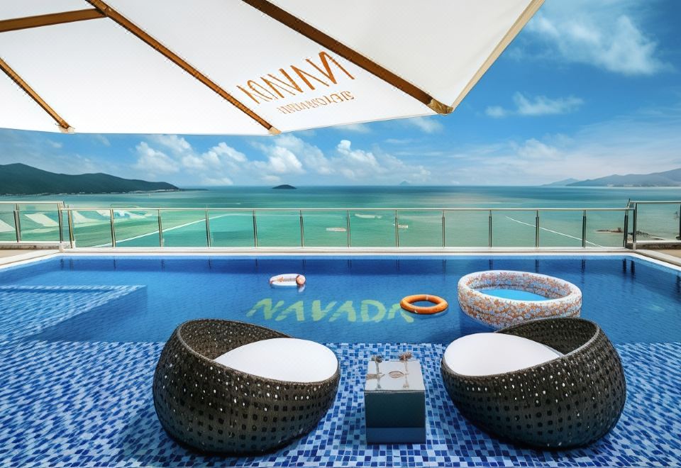 a rooftop patio with a hot tub , lounge chairs , and a view of the ocean at Navada Beach Hotel