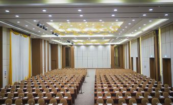 a large conference room with rows of chairs arranged in a semicircle , facing a stage at Grand Fortune Hotel Nakhon Si Thammarat