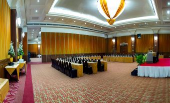 a large conference room with rows of chairs arranged in a semicircle , ready for a meeting or event at Grand Pasundan Convention Hotel