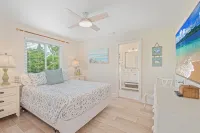 Charming cottage with heated pool, tropical landscaping in prime location.