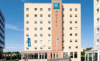 a hotel building with a large sign on the front , indicating its name and location at Ibis Luxembourg Sud