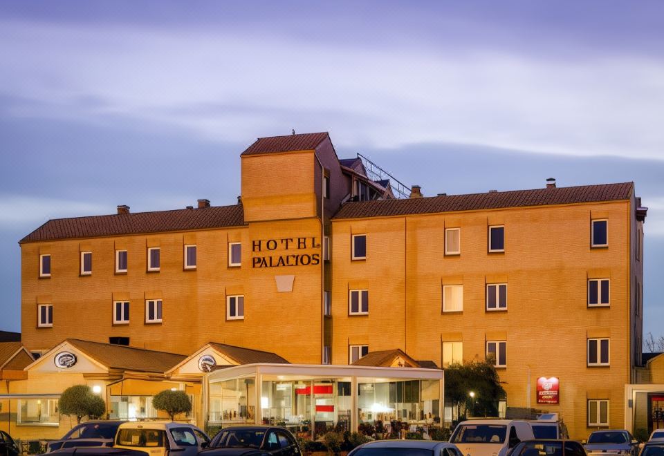 "a large hotel building with the name "" hotel palacio "" written on it , surrounded by cars and other buildings" at Hotel Palacios