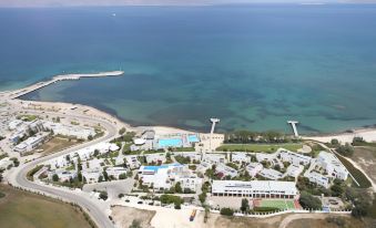 an aerial view of a large body of water , possibly an ocean or a lake , with a hotel complex in the background at Mastichari Bay Hotel