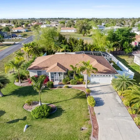 Fenced, private, family friendly villa with exotic poolside views near airport.
