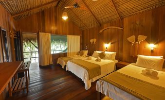 a hotel room with three beds , one on each side of the room and one in the middle at Juma Amazon Lodge
