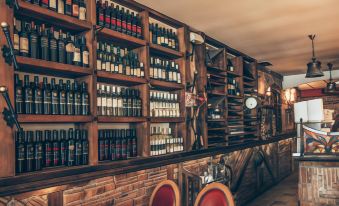 a bar with wooden shelves filled with various bottles of wine , including red , white , and sparkling at Hotel Super 8
