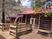 Authentic log cabin nestled in the woods by creek