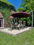 Spacious vacation apartment with fireplace and barrel sauna in the sheltered garden.