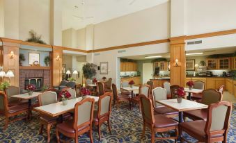 a dining room with several tables and chairs arranged for a group of people to enjoy a meal together at Homewood Suites by Hilton Dayton - South/Dayton Mall