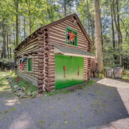 Rustic Rest Log Cabin, with hot tub and trout stream, near Poconos attractions.