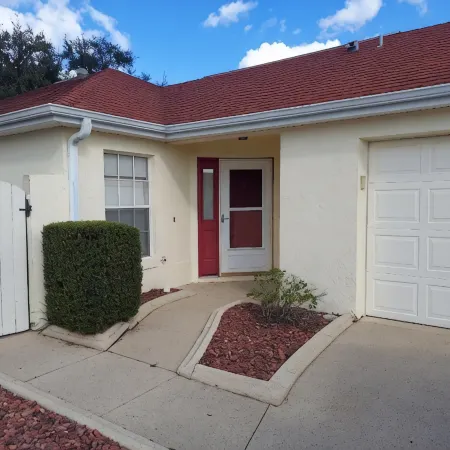 Courtyard Villa with gas golf cart located between two Town Squares!