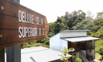 "a wooden sign for the "" deluxe , 1 3 , 1 4 , superior , 1 1 , 2 "" hotel is displayed in front of a" at AYANA Holiday Resort