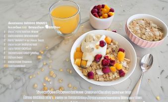 a bowl of cereal topped with yogurt and fruit is sitting on a table , accompanied by a glass of orange juice at Auckland Airport Motel