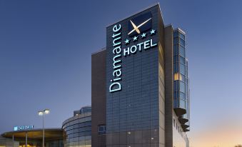 "a tall building with a sign that reads "" diamante hotel "" prominently displayed on the side of the building" at Hotel Diamante