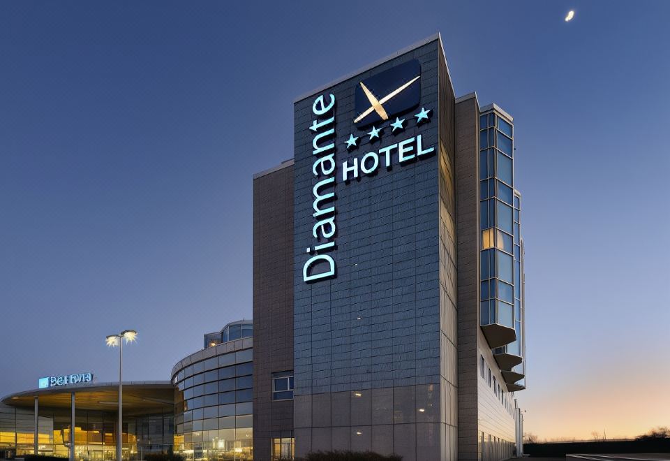 "a tall building with a sign that reads "" diamante hotel "" prominently displayed on the side of the building" at Hotel Diamante