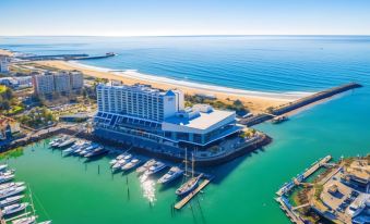 an aerial view of a resort with multiple buildings and boats docked in the harbor at Tivoli Marina Vilamoura