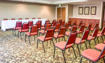 a conference room with rows of chairs arranged in a semicircle and a table in the center at Comfort Suites Gadsden Attalla