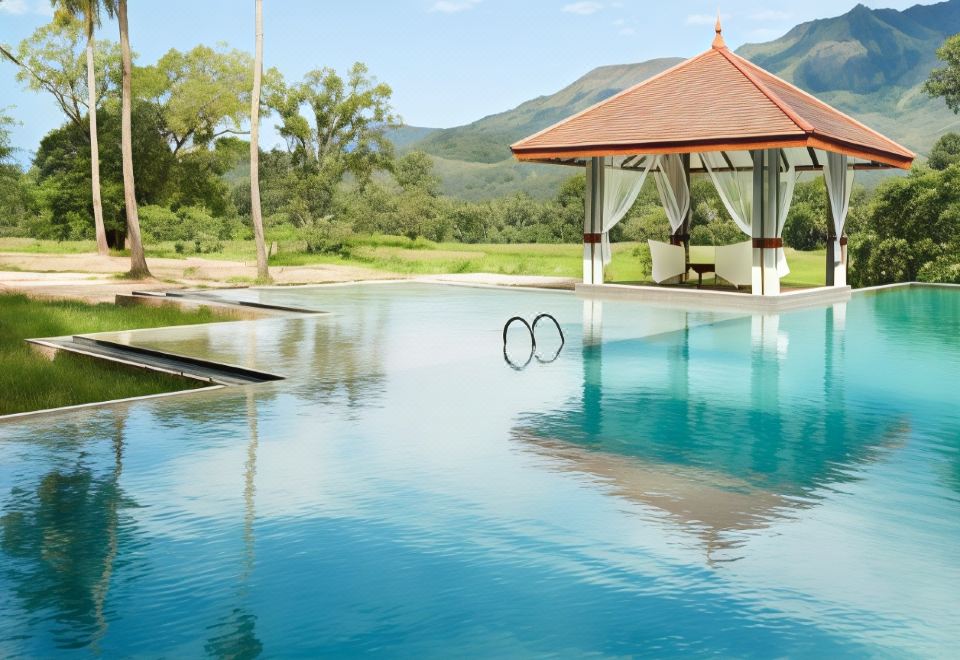 a beautiful outdoor pool area with a gazebo and mountains in the background , creating a serene atmosphere at Jetwing Kaduruketha