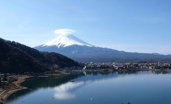 a snow - covered mountain with a lake in the background , creating a serene and picturesque scene at Mizno Hotel